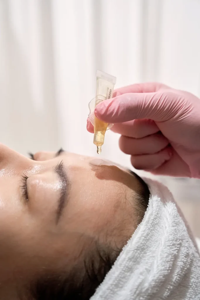 Preparing vitamin and hyaluronic acid (HA) before a NanoMeso treatment at SKIN BAR.